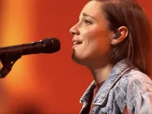 Sarah Kroger, a Catholic worship leader, takes part in leading the faithful in praise and worship at the National Eucharistic Congress in Indianapolis.