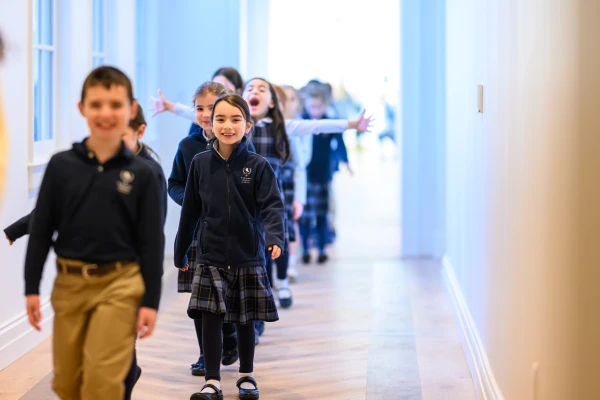 Students walk through the hallway of St. Benedict Classical Academy on its opening day, Dec. 2, 2024. Credit: Adam Richins Photography