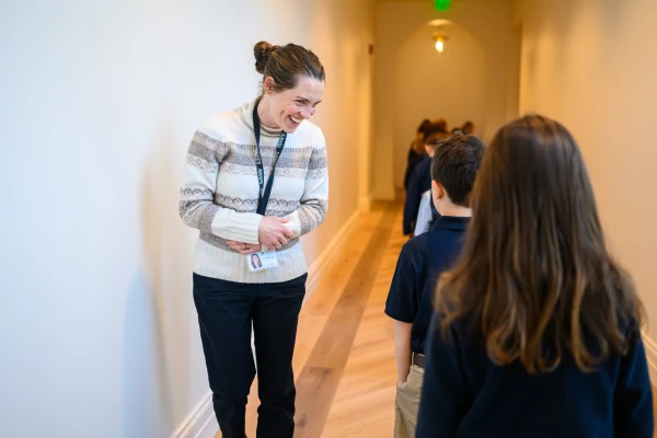 Director of Operations Riley Casey greets students as they walk to class at St. Benedict Classical Academy on its opening day, Dec. 2, 2024. Credit: Adam Richins Photography