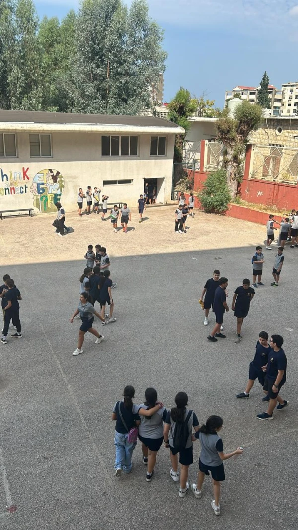 Students gather outdoors during a break on the playground at Apotres Jounieh. Credit: Noelle El Hajj