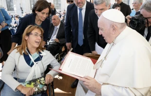 Giulia Cirillo gives Pope Francis a report from Catholics with disabilities on Sept. 21, 2022. Vatican Media