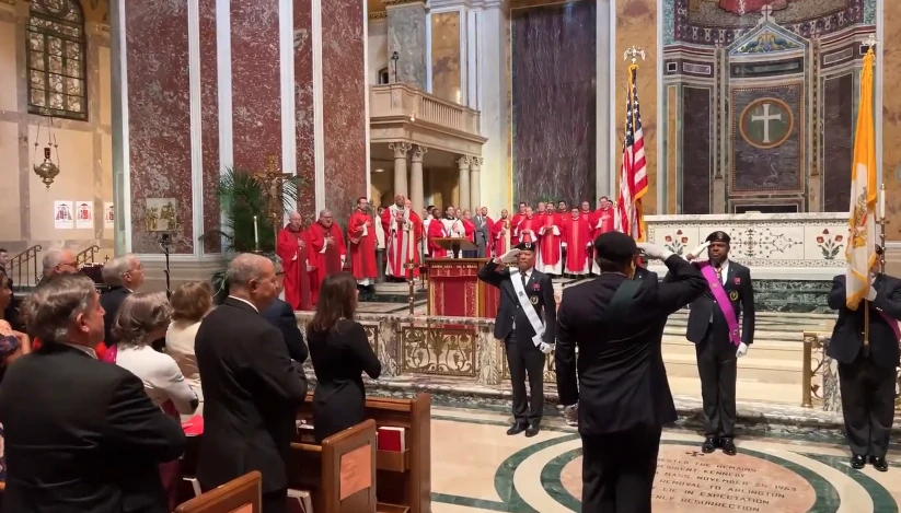 The faithful stand at attention for the national anthem at the archdiocesan Red Mass at the Cathedral of St. Matthew the Apostle, Sunday, Oct. 6, 2024.?w=200&h=150