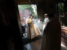 Bishop Robert J. Brennan of Brooklyn holds the Eucharist as he enters Our Lady of Lebanon Maronite Cathedral in Brooklyn, New York, on May 26, 2024. The visit was part of the New York leg of the National Eucharistic Pilgrimage.