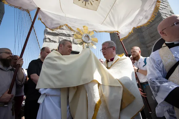 Bishop Gerardo Colacicco of the Archdiocese of New York hands a monstrance to Bishop Robert Brennan of Brooklyn during a National Eucharistic Pilgrimage procession across the Brooklyn Bridge on May 26, 2024. Credit: Jeffrey Bruno/CNA