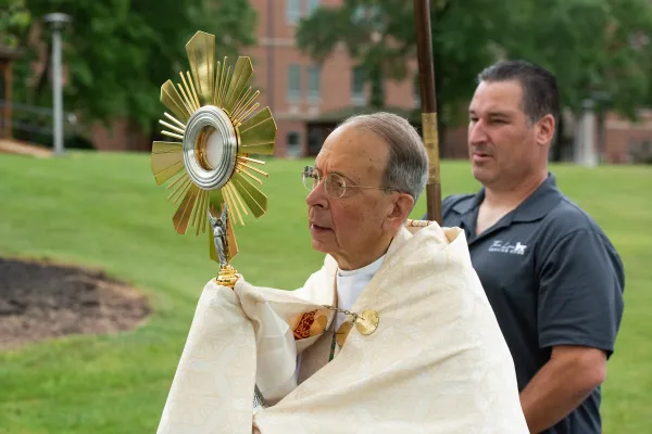 Archbishop William Lori of Baltimore holds the monstrance at the head of the procession. Credit: Jeffrey Bruno
