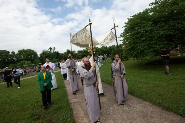 Franciscan Friars of the Renewal hold the processional canopy as the pilgrimage continues. Credit: Jeffrey Bruno