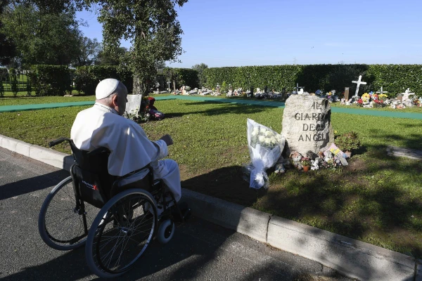 Pope Francis prays silently after laying white roses on a memorial stone marking the “Garden of Angels” at Rome’s Laurentino Cemetery on All Souls’ Day, Nov. 2, 2024. Vatican Media