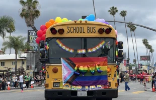 A school bus with rainbow-colored balloons, a Pride flag, and “love its love” signs drives in the Los Angeles Pride parade in Hollywood on June 11, 2023. Credit: Shutterstock