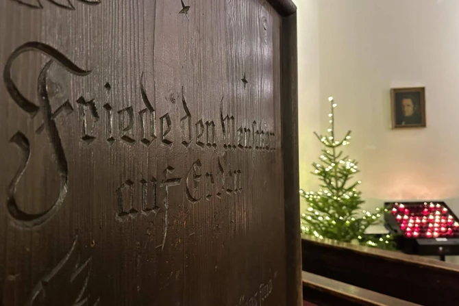 Candles burn behind the entrance to the Silent Night Chapel