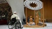 Pope Francis stops for a brief prayer in front of the Bethlehem Nativity in the Vatican's Paul VI Hall during its presentation and a meeting with some of the people involved in its creation on Dec. 7, 2024.