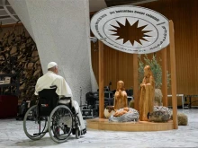 Pope Francis stops for a brief prayer in front of the Bethlehem Nativity in the Vatican's Paul VI Hall during its presentation and a meeting with some of the people involved in its creation on Dec. 7, 2024.