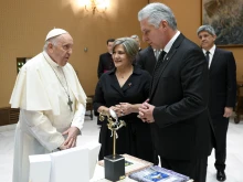 Cuban President Miguel Díaz-Canel and his wife, Lis Cuesta Pedraza, present gifts to Pope Francis during their meeting on Tuesday, June 20, 2023, at the Vatican.