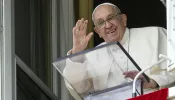 Pope Francis waves from a window of the Apostolic Palace at the crowds gathered in St. Peter's Square for his weekly Angelus address on Sunday, Sept. 22, 2024.