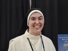 Sister Tonia of the Heart of Jesus Borsellino at the booth for the Mercedarian Sisters of the Blessed Sacrament at SEEK25 in Salt Lake City on Jan. 3, 2025.