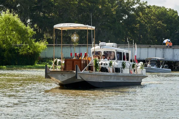 The Fête-Dieu du Teche is a traditional in the bayou organized by the Community of Jesus Crucified. This boat carries the Blessed Sacrament in 2023. In the 2024 procession, a "floating Church" pushed by a large tugboat will follow close behind the Blessed Sacrament houseboat. Credit: Photo courtesy of the CJC