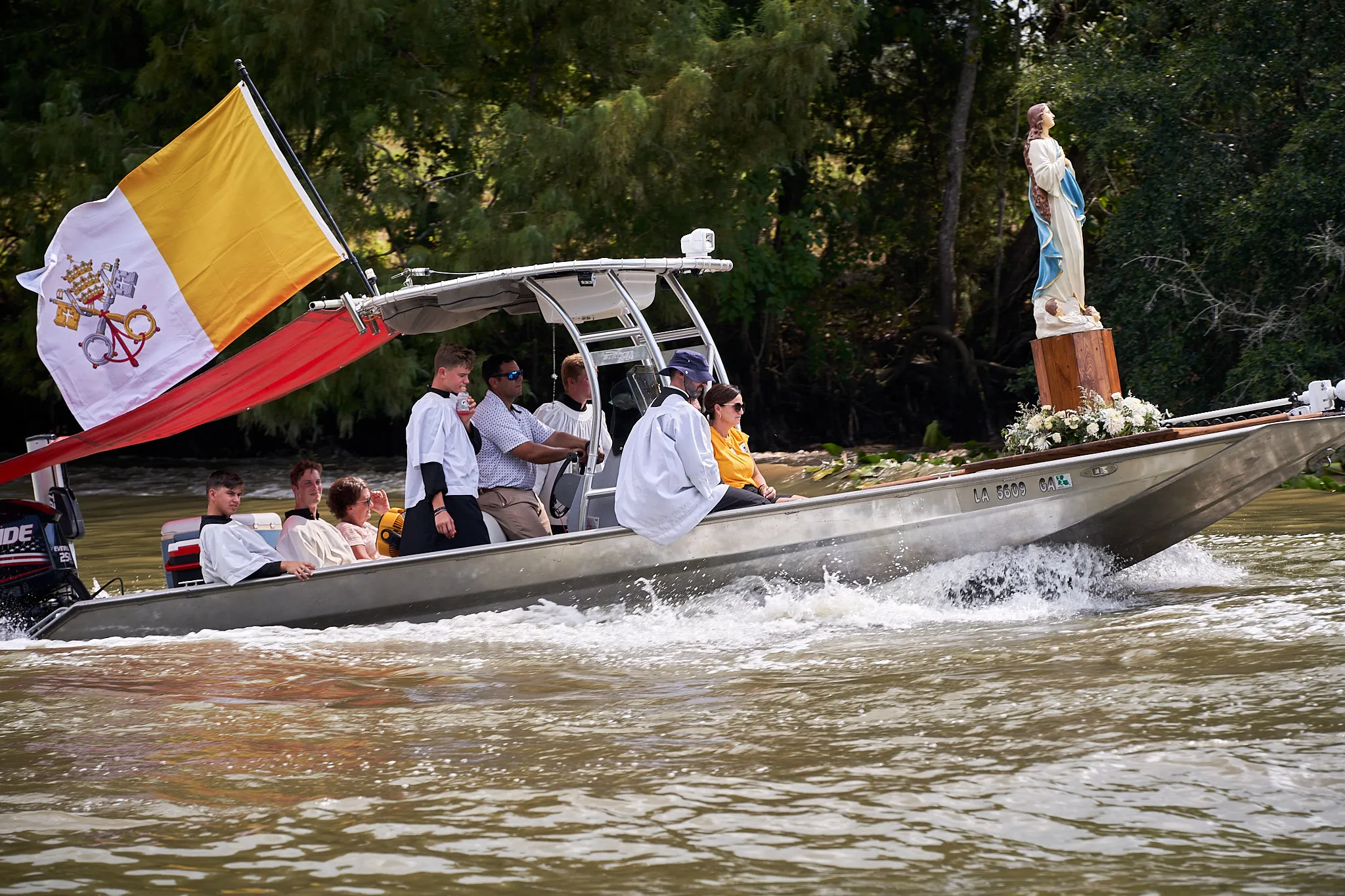 The Fête-Dieu du Teche, an annual procession in the bayou organized by the Community of Jesus Crucified in 2023. This boat carries a state of the Assumption, following a boat carrying the Blessed Sacrament.?w=200&h=150