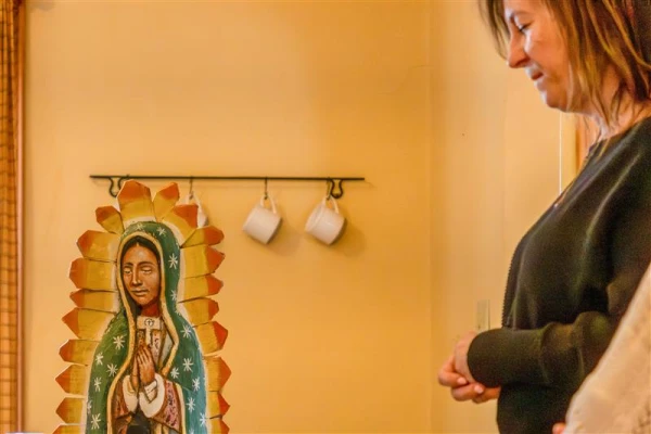 Heather Perry, who along with her husband, Doug, donated the Guadalupe House to Franciscan University of Steubenville prays during the home blessing ceremony. Credit: Ben Glaser/Franciscan University