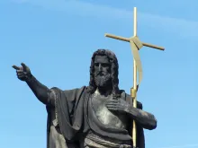 Statue of St. John the Baptist with golden cross, Charles Bridge, Prague, Czech Republic.