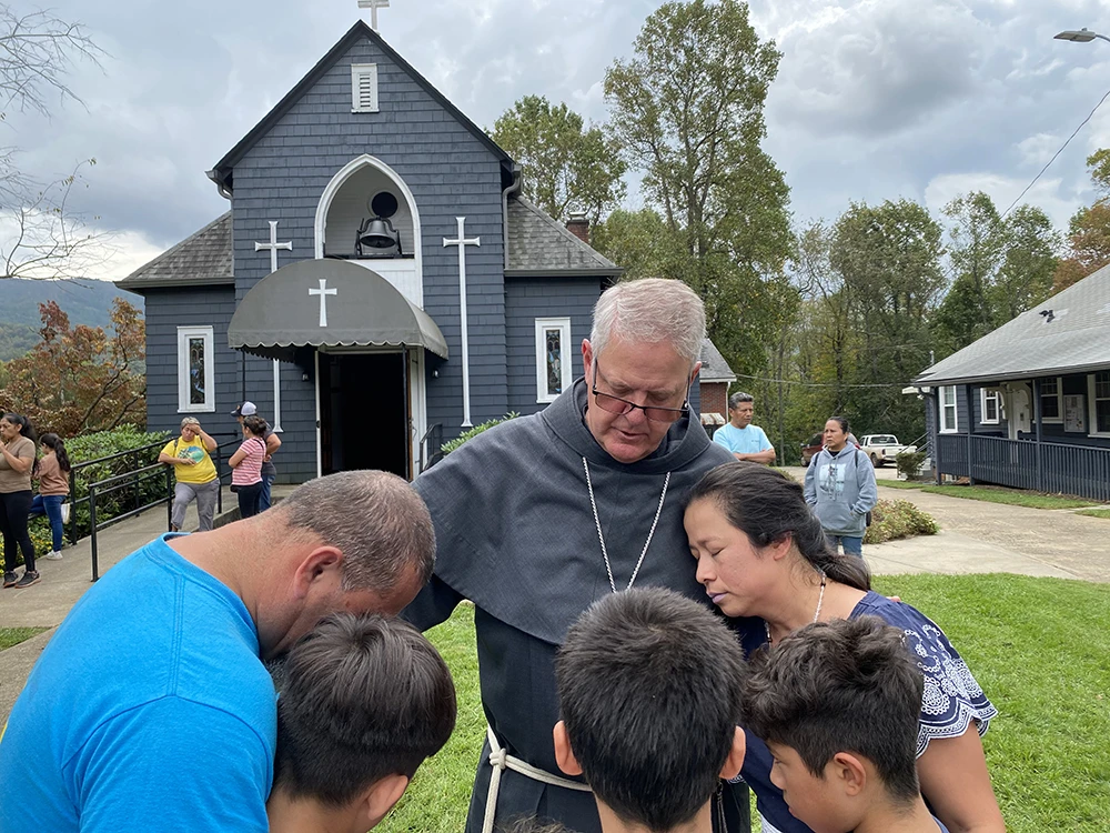 Bishop Michael Martin prays with victims of Hurricane Helene while surveying storm damage at Swannanoa, North Carolina, Friday, Oct. 4, 2024.?w=200&h=150