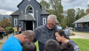 Bishop Michael Martin prays with victims of Hurricane Helene while surveying storm damage at Swannanoa, North Carolina, Friday, Oct. 4, 2024.