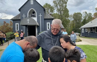 Bishop Michael Martin prays with victims of Hurricane Helene while surveying storm damage at Swannanoa, North Carolina, Friday, Oct. 4, 2024. Credit: Diocese of Charlotte