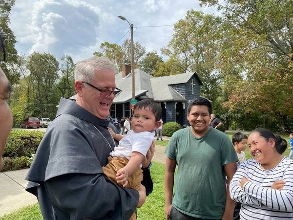 Bishop Michael Martin greets a young Catholic while surveying storm damage at Swannanoa, North Carolina, Friday, Oct. 4, 2024. Credit: Diocese of Charlotte