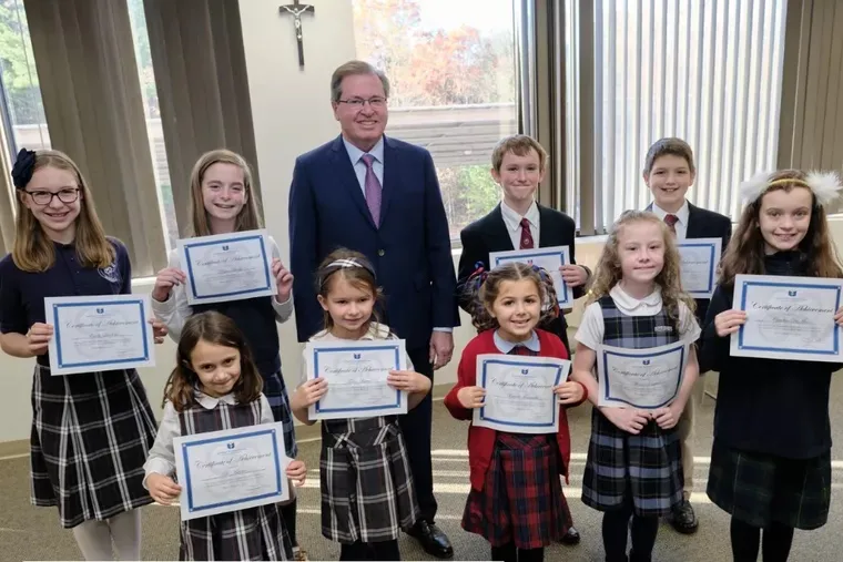 Students who are all winners of the St. Joseph art contest stand alongside Thomas Carroll, superintendent of schools for the Archdiocese of Boston.?w=200&h=150