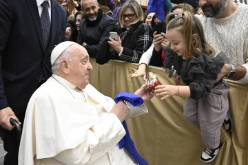 During his audience with Italian Catholic educators, Pope Francis interacts with a young girl at the Paul VI Audience Hall at the Vatican on Jan. 4, 2025.