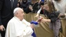 During his audience with Italian Catholic educators, Pope Francis interacts with a young girl at the Paul VI Audience Hall at the Vatican on Jan. 4, 2025.