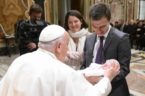 Pope Francis greets a baby while meeting with the academic community of the John Paul II Pontifical Theological Institute for Marriage and Family Sciences in the Vatican, Monday, Nov. 25, 2024. Credit: Vatican Media