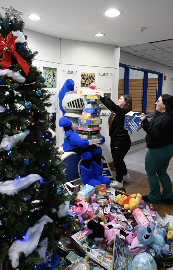 A volunteer stacks toys at Mount Saint Mary College as part of the school's annual toy drive in Newburgh, New York, December 2024. Credit: Lee Ferris