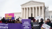 Demonstrators rally on the steps of the United States Supreme Court on Dec. 4, 2024, as justices heard oral arguments in a challenge to a Tennessee law banning transgender surgeries for minors.