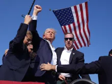 Republican presidential candidate former President Donald Trump is surrounded by U.S. Secret Service agents at a campaign rally, Saturday, July 13, 2024, in Butler, Pennsylvania.