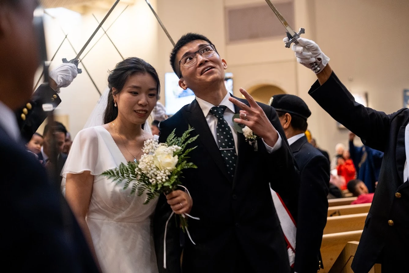 A groom flashes a peace sign at wedding-goers while processing out of St. Mary’s Church in Vancouver, British Columbia, Canada, after having his marriage sacramentally blessed at the Marriage Mass on Oct. 19, 2024.?w=200&h=150