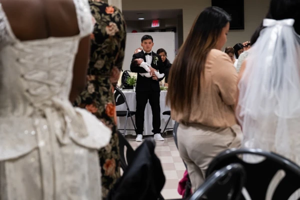 A groom holds a baby at the reception following the Marriage Mass at St. Mary’s in Vancouver on Oct. 19, 2024. Credit: Nicholas Elbers/The B.C. Catholic