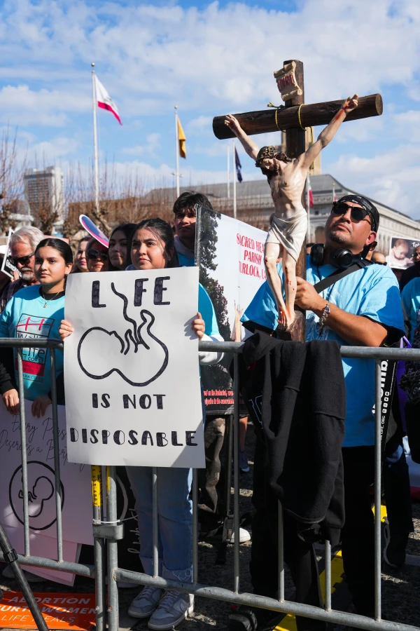 Participants in the Walk for Life West Coast hold up signs and a crucifix during the march through the streets of San Francisco on Saturday, Jan. 25, 2025. Credit: Francisco Valdez/Walk for Life