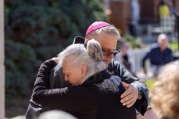 Bishop Michael Martin embraces a victim of Hurricane Helene while surveying storm damage at Waynesville, North Carolina, Sunday, Oct. 6, 2024. Credit: Diocese of Charlotte