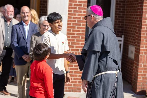 Bishop Michael Martin greets parishioners while surveying storm damage in Waynesville, North Carolina, Sunday, Oct. 6, 2024. Credit: Diocese of Charlotte