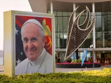 A smiling Pope Francis is depicted on a sign outside the APEC Haus in Port Moresby, Papua New Guinea, on the occasion of the pontiff's visit, Sept. 7, 2024.