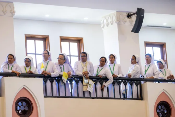 sisters listening to pope francis in dili's cathedral