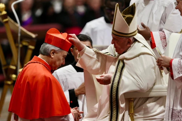 Pope Francis places the red biretta on Cardinal Domenico Battaglia, archbishop of Naples, during the consistory for the creation of 21 new cardinals in St. Peter's Basilica, Dec. 7, 2024. Credit: Daniel Ibáñez/CNA