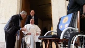 Father Enrique “Kike” Figaredo on Oct. 23, 2024, presents Pope Francis with a wheelchair made by land mine survivors in Cambodia.