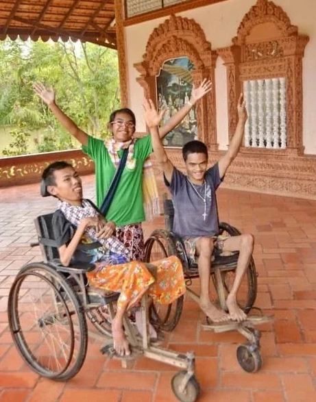 Two disabled youth in "Mekong" wheelchairs. Credit: Courtesy of Father Kike Figaredo