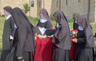 Religious sisters of the Benedictines of Mary, Queen of Apostles, sing as the process with the body of their late foundress, Sister Wilhelmina Lancaster, on May 29, 2023, at their abbey near Gower, Missouri. The sisters exhumed the nun's body on May 18 and discovered that it was apparently intact, four years after her death and burial in a simple wooden coffin. Joe Bukuras/CNA