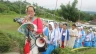 Women baptized by Prem Bhai climb to his memorial singing devotional songs during a 2018 observance of the Catholic missionary.