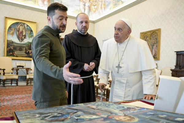 Ukraine President Volodymyr Zelenskyy presents Pope Francis with a painting during their meeting on Oct. 11, 2024, at the Vatican. Credit: Vatican Media